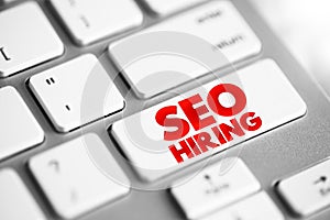 Seo Hiring text button on keyboard, concept background
