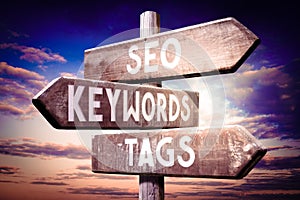 SEO, keywords, tags - wooden signpost, roadsign with three arrows