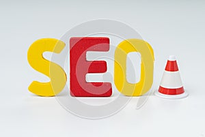 SEO, Search Engine Optimization ranking concept, alphabets abbreviation SEO with traffic cone for under construction on white
