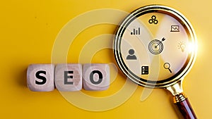 SEO Search Engine Optimization on wooden cubes with magnifying glass. Website Internet Business Technology Concept