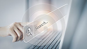 SEO search icon, hands touch the computer notebook screen to search for information.