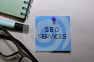 SEO Services text on sticky notes isolated on office desk