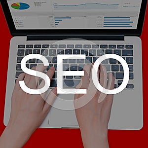 A seo specialist works at a laptop. A man studies traffic analytics on the site. Search engine optimization, increased sales.