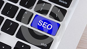 SEO text on blue button of computer keyboard