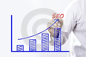 SEO text with hand of young businessman business concept