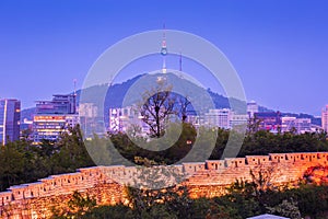 Seoul city at night and the ancient old wall, Namsan Mountain and Namsan Tower in the background, Seoul, South Korea