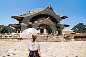 Seoul, South Korea. Gyeongbokgung Palace. Woman in hanbok, traditional Korean dress, costume and clothes. Travel tour and tourism