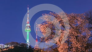 Seoul tower in seoul city at night view in spring with cherry blossom tree and old wall with light, south korea