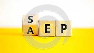 SEP or AEP symbol. Concept words AEP annual enrollment period SEP special enrollment period. Beautiful yellow table white