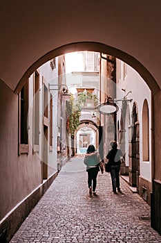 Small backstreet alley under arch arcade in old town Bern, Switz