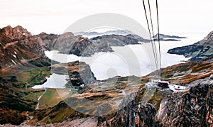 Stand and Rotair Ropeway Gondola station on cliff and alpine mountain valley of Titlis in Engelberg, Switzerland