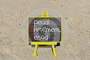 SEP symbol. Concept words SEP Special enrollment period on beautiful black chalk blackboard. Beautiful sand beach background.