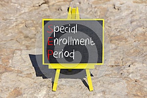 SEP symbol. Concept words SEP Special enrollment period on beautiful black chalk blackboard. Beautiful stone beach background.