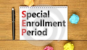 SEP symbol. Concept words SEP Special enrollment period on beautiful white note. Beautiful wooden table wooden background. Medical