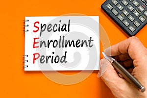 SEP symbol. Concept words SEP Special enrollment period on beautiful white note. Doctor hand. Beautiful orange table orange