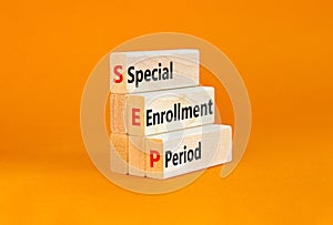 SEP symbol. Concept words SEP Special enrollment period on beautiful wooden block. Beautiful orange table orange background.