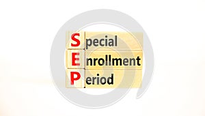 SEP symbol. Concept words SEP Special enrollment period on beautiful wooden block. Beautiful white table white background. Medical