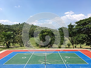 Sepaktakraw court with trees and blue sky background.