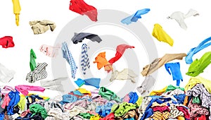 Separate clothing falling at the big pile of clothes on a white