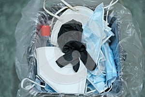 Separate garbage bin full of used protective face mask and gloves,covid19 medical disposal waste