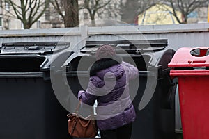 separate garbage collection. Woman throws plastic bottles into a container