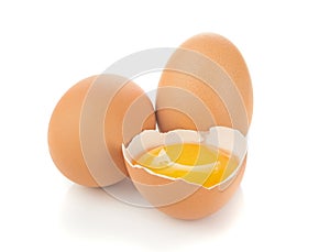 A separated egg yolk and eggs