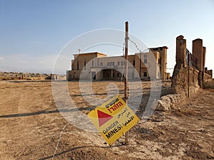 Separated land with a church building marked as dangerous because of mines