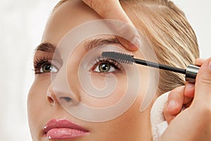 Separating and curling lashes with mascara brush photo