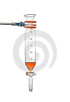 Separating funnel with solution and funnel on stand, isolated on