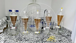 Separation funnels with biological samples after being digested waiting for decantation. Experiment realized in a laboratory