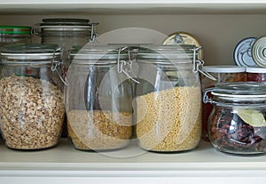 Separation in a kitchen cupboard or pantry with cereals and canned goods