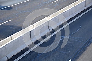 Separation of lanes on the highway by means of heavy concrete barriers. they are used in places where driving directions are too c
