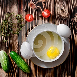 Separation the yolk of egg in little bowl, eggs, cherry tomatoes and fresh cucumbers