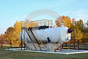 Separator at oilfield production facility, separating oil and gas from the well streams. Crude oil metering station and pipeline