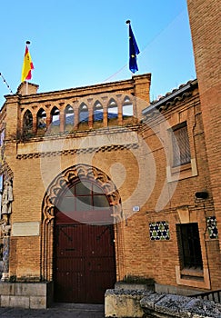 Sephardic Museum entrance with Spain and Europe flags hanging on the top in Toledo, Spain