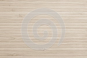 Sepia beige wood texture bamboo wooden kitchen cutting board grainy detail background in light brown color