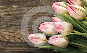 Sepia card with pink tulips on wood background