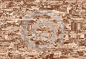 A sepia duotone crowded urban cityscape background with hundreds of densely packed buildings