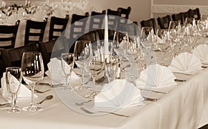 SEPIA - Festive table arrangement with glasses and served and cutlery