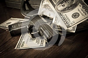 Sepia filtered of gun and dollar bills