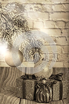 Sepia pine branch with christmas tree decorations and gifts