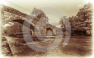 Sepia retro view Abergorlech arched stone bridge