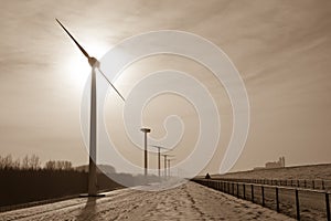 Sepia scenery of Windmills in a snowy landscape