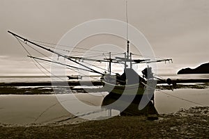 Sepia silhouette of a moored fishing boat