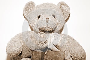 Sepia teddy bear with bars of soap and facecloths