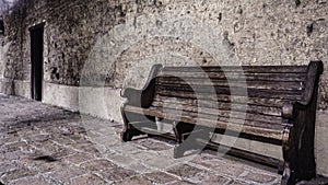 Sepia toned image of bench at the San Juan Capistrano Mission in California