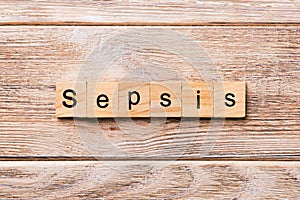 Sepsis word written on wood block. Sepsis text on wooden table for your desing, concept photo
