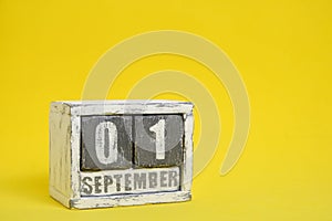 September 01 wooden calendar standing yellow background with an empty space for text.Knowledge Day.