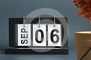September 06, Date design with a black wooden calendar for a business.