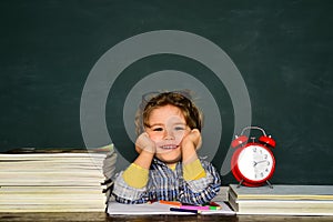 September 1. Blackboard copy space. Back to school. Funny little boy pointing up on blackboard. Great study achievement.